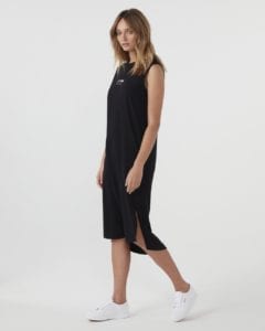 side view of gigi dress in black worn with DOF tommy white sneakers