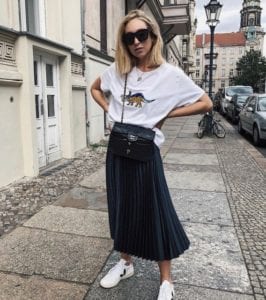black pleat skirt worn with tee and sneakers