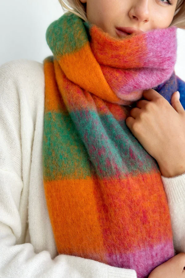 close up of bright coloured scarf wrapped around model