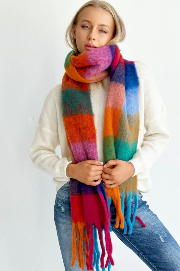 bright coloured scarf with tassels on model